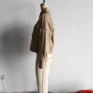 Detail der khakifarbenen Utility-Jacke mit Baumwoll-Canvas-Textur und Schulterklappen