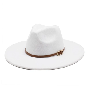 Detailed close-up of a white wool jazz hat with a brown leather belt buckle and gold metal pin