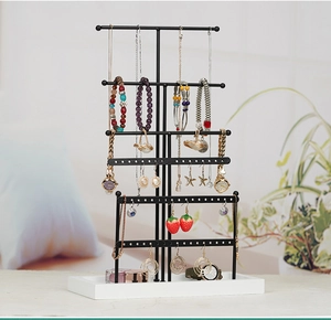 Detailed 6-tier black metal jewelry organizer with white base and earring storage holes