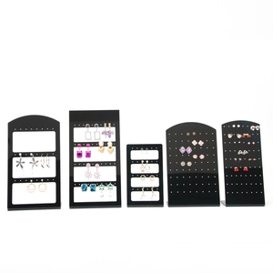 Detail of five black acrylic earring display stands in arched and rectangular shapes