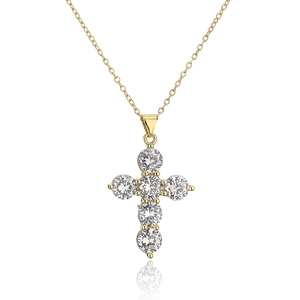 Elegant gold cross pendant necklace with sparkling cubic zirconia on white background