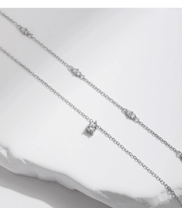 Macro shot of D-color moissanite pendants on a double-layer S925 sterling silver chain
