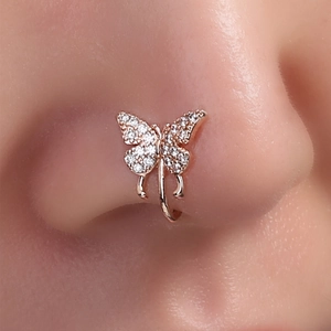 Close-up of model wearing a rose gold butterfly nose clip with shimmering crystals