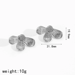 Detail of silver floral stud earrings showing dimensions of 31.8mm and pleated metal texture