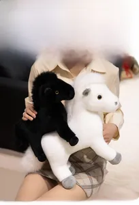 Nahaufnahme der flauschigen weißen und schwarzen Plüschponys aus weichem Kunstfell