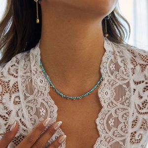 Women's gold and turquoise beaded necklace shown on model neck for stylish look