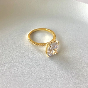 Macro detail of a square-cut zirconia center stone on a gold-plated S925 silver ring
