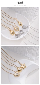 Detailed view of heart, star, and teardrop gold and silver pendants with clear zircons