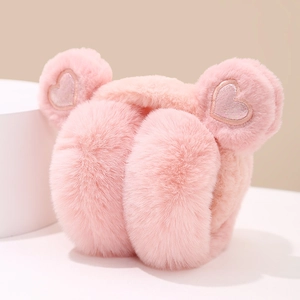 Detail of pink plush earmuffs with soft faux fur and shimmering heart sequins for winter