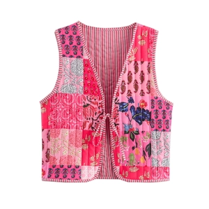 Detail of the colorful quilted patchwork pattern and tie closure on the pink cotton vest