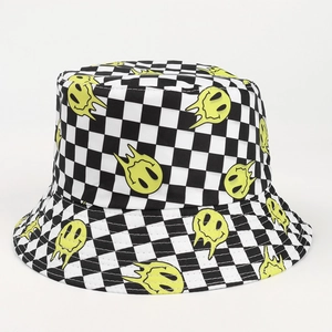Detail of checkered bucket hat featuring a melting yellow smiley face print on canvas