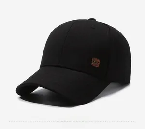 Detail view of cotton baseball cap with KWC embossed leather patch on the side