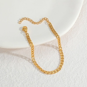 Detailed shot of gold Cuban link chain jewelry with lobster clasp and extension