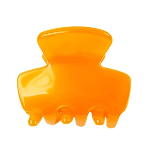 Detail view of mini translucent orange acetate hair claw clip with glossy finish