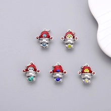 Macro shot of S925 sterling silver spacer beads with colorful enamel folk character designs