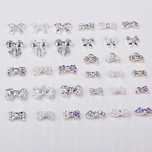 Detailed collection of 24 alloy bowknot nail art charms with crystals and pearls