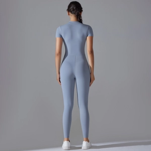 Rear view of a霧霾 blue short sleeve athletic jumpsuit showing high support and sleek seams