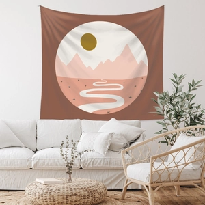 Detail view of Bohemian tapestry with mountain and sun landscape hung over a sofa