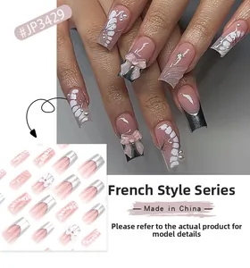 Detail of pink French press-on nails with 3D white bows and silver tips set