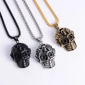 Detailed trio of punk skull pendants in matte black, silver, and gold finish steel