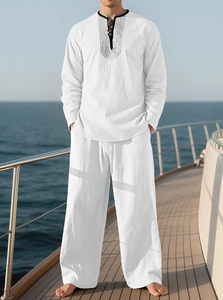 Detailed view of white linen long sleeve shirt with geometric patterns and drawstring pants