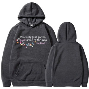 Flat lay of gray Christmas hoodie with Jingle Some of the Way print and front pocket