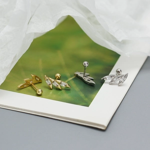 Macro view of marquise-cut crystal leaf ear studs with screw back in gold and silver