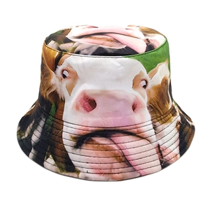 Detail of funny cow face print on cotton bucket hat showing stitching and fabric texture