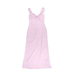Detailed flat lay of pink backless dress showing ruffle straps and front lace-up detail