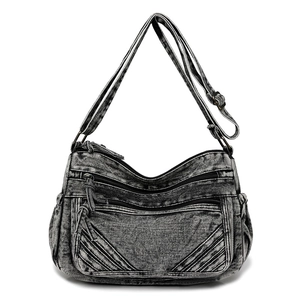 Detailed macro view of dark grey washed denim fabric and zippered front pockets