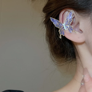 Detail view of purple butterfly ear cuff with gold metal trim and resin finish