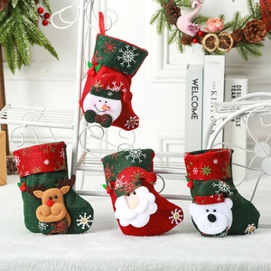 Close-up of four festive Christmas stockings with snowman, reindeer, and santa motifs