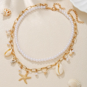Close-up of bohemian double-layer necklace with sea shells, starfish charms, and pearls