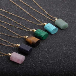 Close-up of semi-precious stone perfume bottle pendants on elegant gold chains