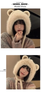 Detail of plush bear ear hat showing long faux fur texture and warm earflaps in light camel