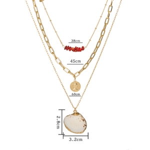 Three-layer gold necklace with red stones, coin pendant, and natural shell charm
