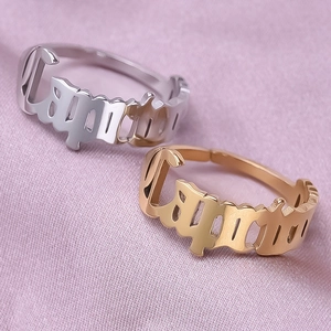 Macro shot of gold and silver Capricorn zodiac open rings on purple silk fabric background