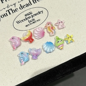 Handmade ocean-themed kids press-on nails featuring glitter resin sea animals in candy colors