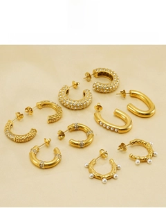 Detailed display of 18K gold plated hoop earrings with pearls and crystals on silk