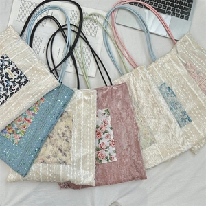 Flat lay of lace canvas tote bags with floral butterfly patches in various pastel colors