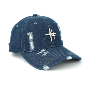 Detail of distressed navy denim baseball cap with a silver rhinestone cross star stud