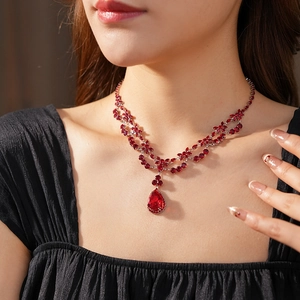 Close-up of model wearing luxury red drop-shaped zircon flower necklace in vintage style