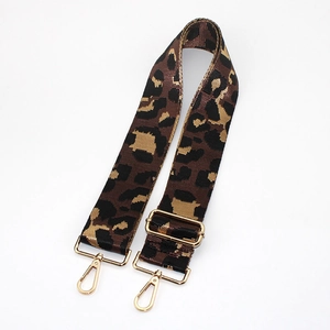 Close-up of adjustable leopard print bag strap with high-quality gold metal buckles