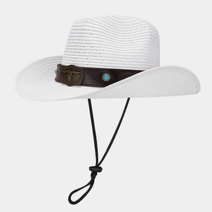 Close-up of white straw cowboy hat with bull head metal buckle and turquoise beads decoration