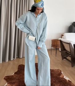 Close-up of light blue linen blend loose shirt and wide-leg trousers two-piece set
