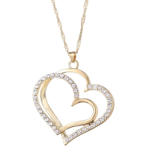 Close-up of golden double heart pendant with sparkling rhinestones on twisted metal chain