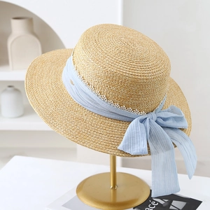 French straw hat with wide brim, blue chiffon ribbon, and white lace bow detail