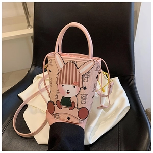 Detail of pink mini bucket bag with cartoon rabbit patterns and MAIDUOXIONG lettering