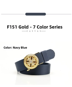 Close-up of navy blue canvas belt with gold cross buckle and inlaid rhinestones