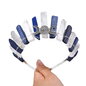 Handmade crown with blue and clear crystals, silver wire, and lunar symbols on white background